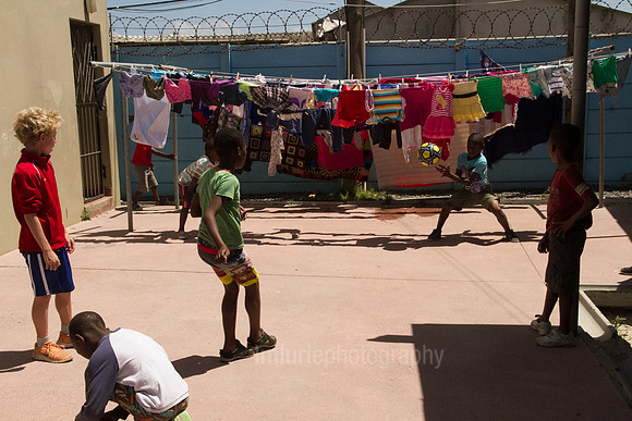 Kids playing soccer at Baphumelele Orphanage